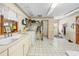 Large laundry room features tiled floor, sink, and laundry machines at 10193 Wallien Dr, Brooksville, FL 34601