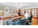 Bright living room with a decorative rug, comfortable seating, and elegant chandelier at 10193 Wallien Dr, Brooksville, FL 34601