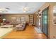 Cozy living room featuring hardwood floors, leather furniture, and a sliding glass door at 10193 Wallien Dr, Brooksville, FL 34601