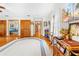 Open-concept living area featuring wood floors, large rug, and a view into the main bedroom at 10193 Wallien Dr, Brooksville, FL 34601