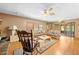 Comfortable living room with ceiling fan, fireplace, and sliding glass doors to the outside at 10193 Wallien Dr, Brooksville, FL 34601