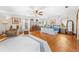 Large main bedroom with beautiful hardwood floors, a ceiling fan, and a seating area at 10193 Wallien Dr, Brooksville, FL 34601