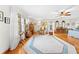 A large main bedroom featuring hardwood floors, a ceiling fan, and lots of natural light at 10193 Wallien Dr, Brooksville, FL 34601