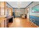 Cozy office with classic wallpaper, hardwood floors, built-in desk, and an abundance of natural light at 10193 Wallien Dr, Brooksville, FL 34601