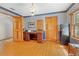 Classic office space with hardwood floors, custom desk, and traditional wallpaper at 10193 Wallien Dr, Brooksville, FL 34601