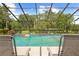 Screened-in pool area with lounge chairs and view of the backyard at 10193 Wallien Dr, Brooksville, FL 34601