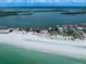 Breathtaking aerial view of a beachfront home with pristine sands and sparkling water at 1114 Mandalay Pt, Clearwater Beach, FL 33767