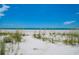 Beautiful beach view featuring white sand, blue skies, and calm blue water at 1114 Mandalay Pt, Clearwater Beach, FL 33767