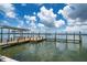 Well-maintained private dock with a boat lift, offering direct access to the open water for boating and recreation at 1114 Mandalay Pt, Clearwater Beach, FL 33767