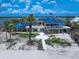 Stunning exterior elevation with a blue roof and expansive views of the water at 1114 Mandalay Pt, Clearwater Beach, FL 33767