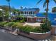 Elegant two-story home with a charming balcony, lush landscaping, and a private entrance at 1114 Mandalay Pt, Clearwater Beach, FL 33767