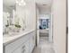 Bathroom with double sinks, a large mirror, and a view into the main bedroom at 11739 Blackbrook Ct, Seffner, FL 33584