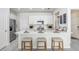 Well-lit kitchen featuring white cabinets, stainless steel appliances, and a breakfast bar with stool seating at 11739 Blackbrook Ct, Seffner, FL 33584