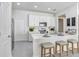 Bright kitchen with stainless appliances, white cabinets, light countertops and seating at the breakfast bar at 11739 Blackbrook Ct, Seffner, FL 33584
