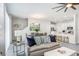 Open-concept living room with modern decor, neutral tones, and a view of the kitchen and dining area at 11739 Blackbrook Ct, Seffner, FL 33584