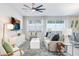 Bright living room with a view of the kitchen and dining area, featuring a modern ceiling fan and decor at 11739 Blackbrook Ct, Seffner, FL 33584