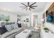 Cozy living room with modern decor, neutral tones, and an open layout to the kitchen and dining area at 11739 Blackbrook Ct, Seffner, FL 33584