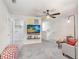Cozy living area with a ceiling fan, a mounted television, and lots of natural light at 11739 Blackbrook Ct, Seffner, FL 33584