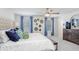 Spacious main bedroom featuring a ceiling fan, and large dresser with blue accents at 11739 Blackbrook Ct, Seffner, FL 33584