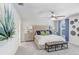Main bedroom featuring a ceiling fan, a window, and a decorative headboard at 11739 Blackbrook Ct, Seffner, FL 33584