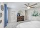 Well-lit main bedroom showcasing a decorative dresser with blue accents and large plant art at 11739 Blackbrook Ct, Seffner, FL 33584