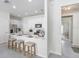Open-concept kitchen with white cabinets, stainless steel appliances, and breakfast bar at 11749 Blackbrook Ct, Seffner, FL 33584
