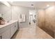 Well-lit bathroom with a walk-in shower, double vanity, and neutral tile, creating a serene atmosphere at 1182 Orlando Blvd, Port Charlotte, FL 33952