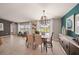 Elegant dining room with a stylish table, modern chandelier, and access to outdoor space at 1182 Orlando Blvd, Port Charlotte, FL 33952