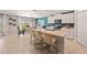 Stylish kitchen with a large island, white cabinets, stainless appliances, and an adjacent dining area at 1182 Orlando Blvd, Port Charlotte, FL 33952