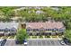 Aerial view of townhomes featuring well-maintained landscaping and a dedicated parking area at 12464 Berkeley Square Dr, Tampa, FL 33626