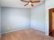 Bedroom featuring a ceiling fan, carpet, and a freshly painted light blue walls at 12464 Berkeley Square Dr, Tampa, FL 33626