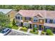 Townhome exterior with colorful facade, manicured landscaping, and convenient parking at 12464 Berkeley Square Dr, Tampa, FL 33626