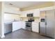 Modern kitchen with stainless steel appliances, white cabinetry, and efficient layout at 12464 Berkeley Square Dr, Tampa, FL 33626
