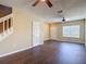 Bright living room featuring hardwood floors, ceiling fans, and a view of the front entry at 12464 Berkeley Square Dr, Tampa, FL 33626