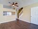 Open-concept living space with hardwood flooring and view of the staircase at 12464 Berkeley Square Dr, Tampa, FL 33626