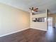 Open living area with hardwood flooring, ceiling fan, and view of the kitchen at 12464 Berkeley Square Dr, Tampa, FL 33626
