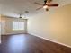 Inviting living room with hardwood floors, ceiling fans, and ample natural light at 12464 Berkeley Square Dr, Tampa, FL 33626