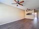 Spacious living room with wood floors, ceiling fans, and a view into the kitchen at 12464 Berkeley Square Dr, Tampa, FL 33626