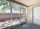 View of screen patio overlooking brick wall, landscaping, and providing a seamless indoor-outdoor transition at 12464 Berkeley Square Dr, Tampa, FL 33626