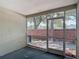 This screened patio looks out onto a brick privacy wall with landscaping and plenty of natural light at 12464 Berkeley Square Dr, Tampa, FL 33626