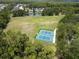 Aerial view of the community featuring tennis courts, a playground, and a pond at 12918 Tar Flower Dr., Tampa, FL 33626