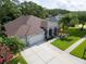 Beautiful aerial shot of a home with three-car garage, mature landscaping and well-maintained lawn at 12918 Tar Flower Dr., Tampa, FL 33626