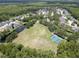Aerial view of the community featuring tennis courts, a playground, pond, and residential area at 12918 Tar Flower Dr., Tampa, FL 33626