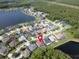 Overhead shot of homes nestled in a community with private pools close to serene lake and greenery at 12918 Tar Flower Dr., Tampa, FL 33626
