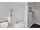 Elegant glass shower showcasing marble style tile work and adjacent soaking tub at 12918 Tar Flower Dr., Tampa, FL 33626