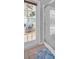 Bathroom featuring a clear glass shower and a door leading to a patio at 12918 Tar Flower Dr., Tampa, FL 33626