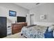 Bedroom with a large TV, a dark dresser, neutral wall color, and comfortable bedding at 12918 Tar Flower Dr., Tampa, FL 33626