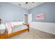 Charming bedroom features a wood-frame bed, floral decorations, and serene blue walls for a cozy ambiance at 12918 Tar Flower Dr., Tampa, FL 33626