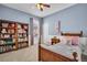 Cozy bedroom with a wooden bed frame, bookshelf, and window with natural light at 12918 Tar Flower Dr., Tampa, FL 33626