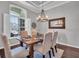 Dining room features a dark wood table, 6 chairs, and a large window at 12918 Tar Flower Dr., Tampa, FL 33626